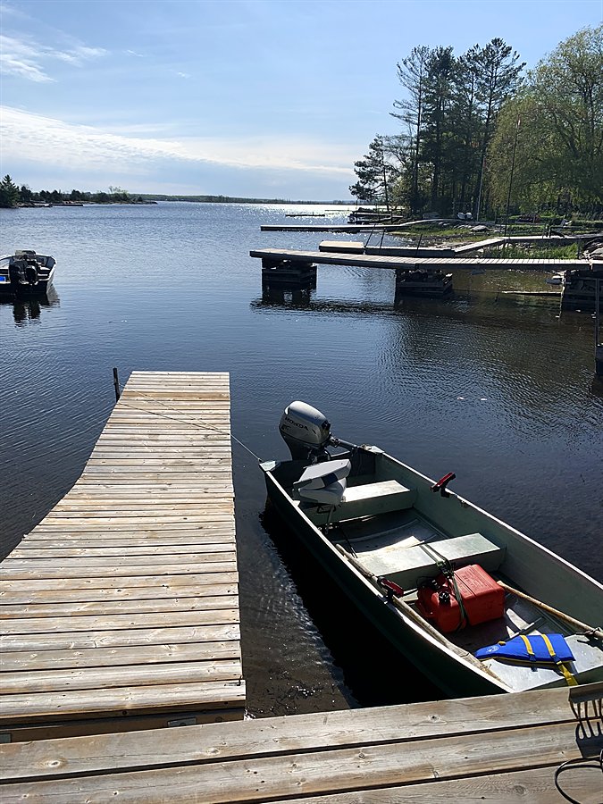 Aluminum fishing boat tied at the dock