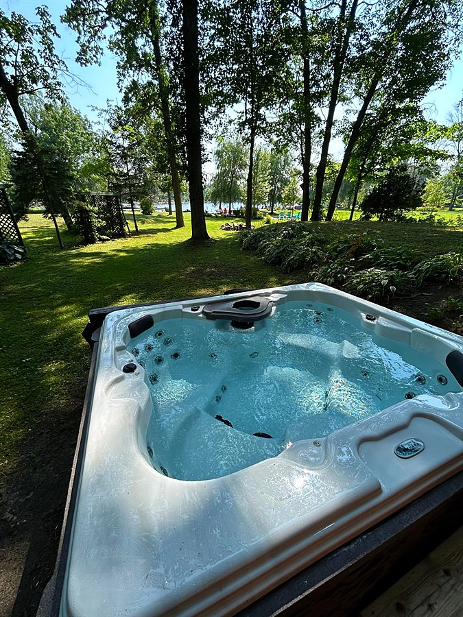 The hot tub looking down the lawn to the water